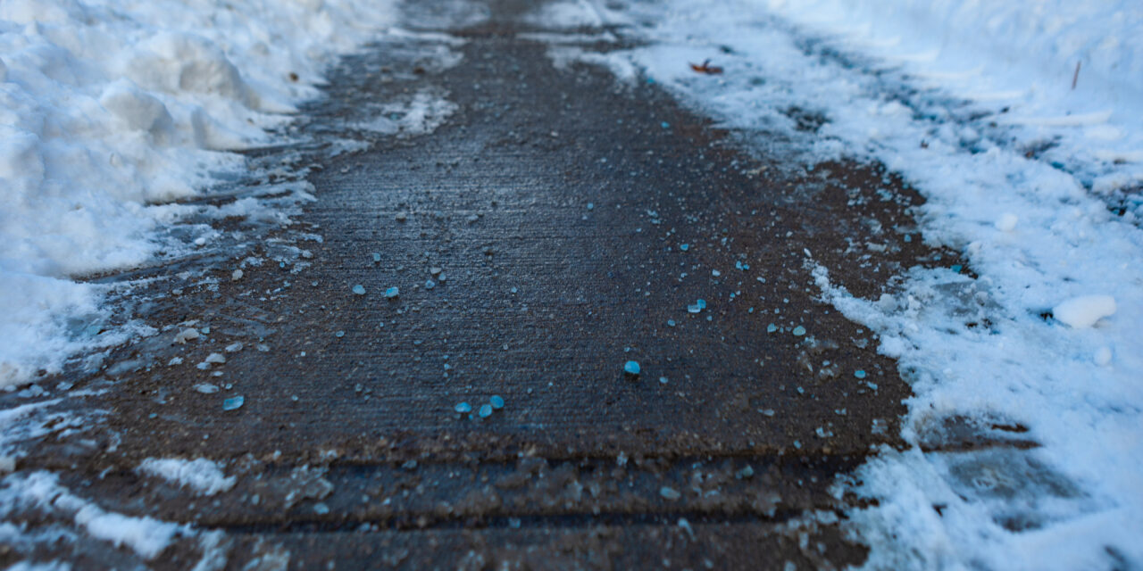 Toronto, CANADA - January 27th, 2019: Canadian blue salt on roads for better melting of ice with liquid magnesium chloride.